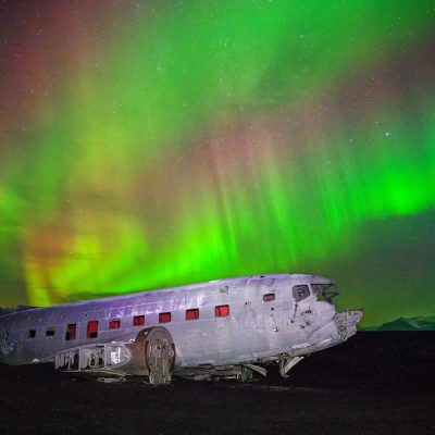 Islande, Solheimasandur. Carcasse d'un avion écrasé, sous une aurore boréale. Photo : Matthew Karsten.